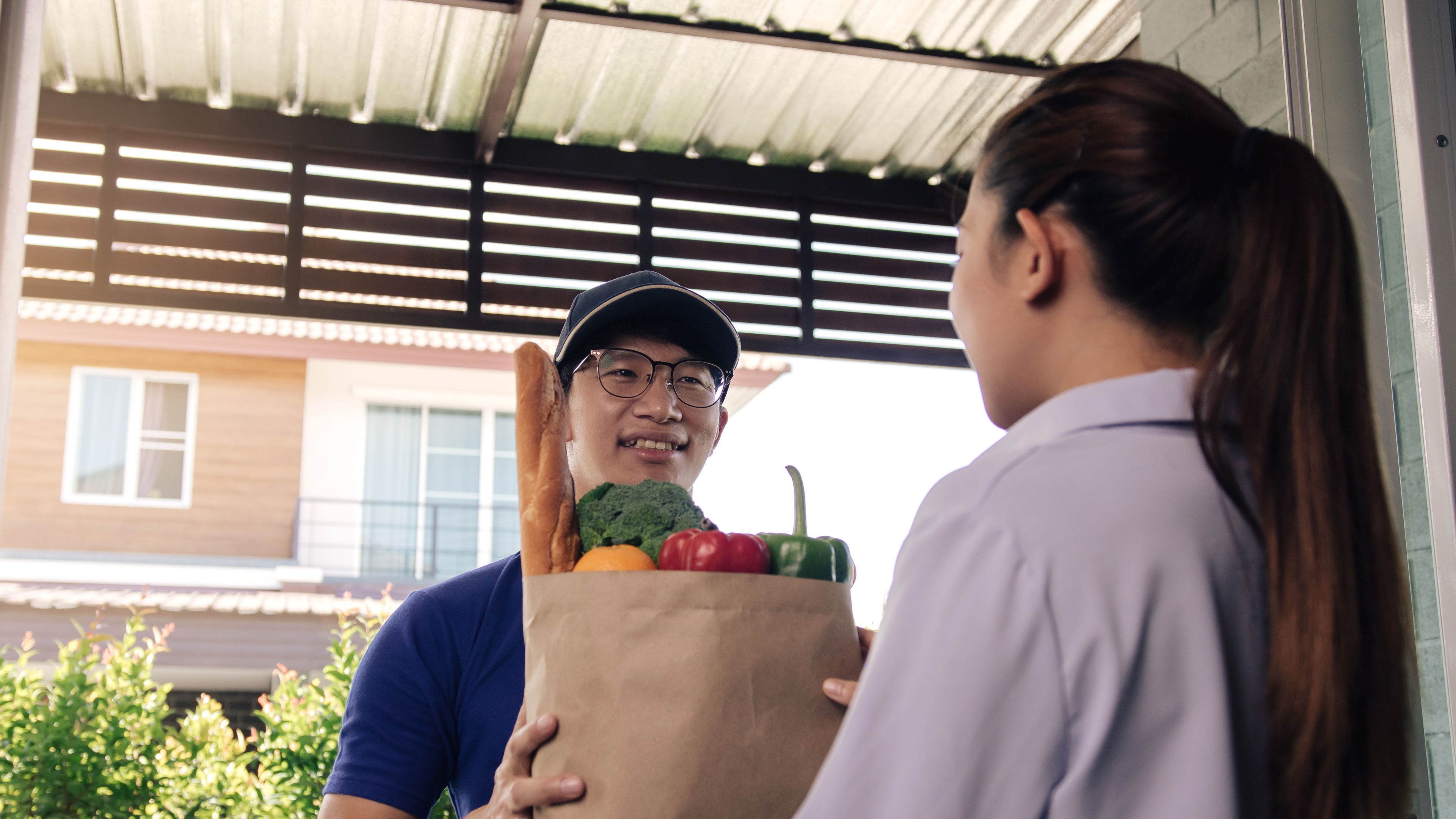 A delivery man delivers groceries. 