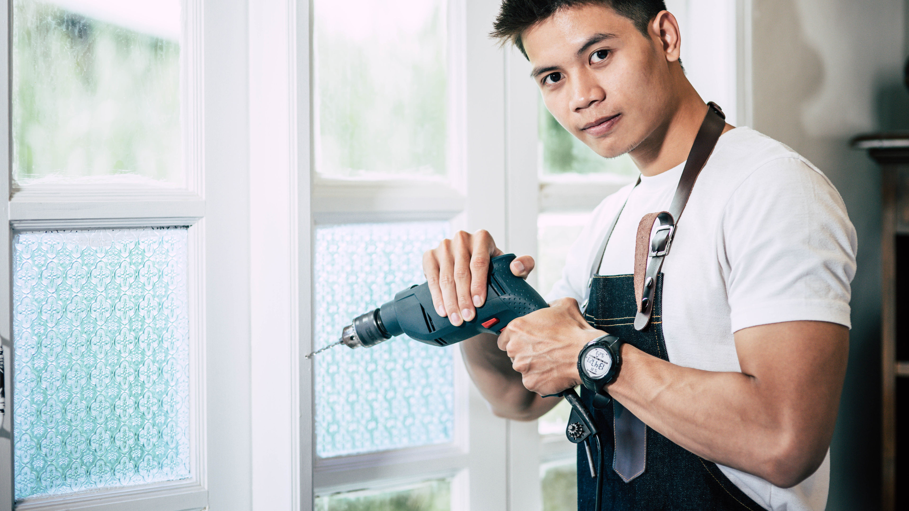 A man with a drilling machine in hand 