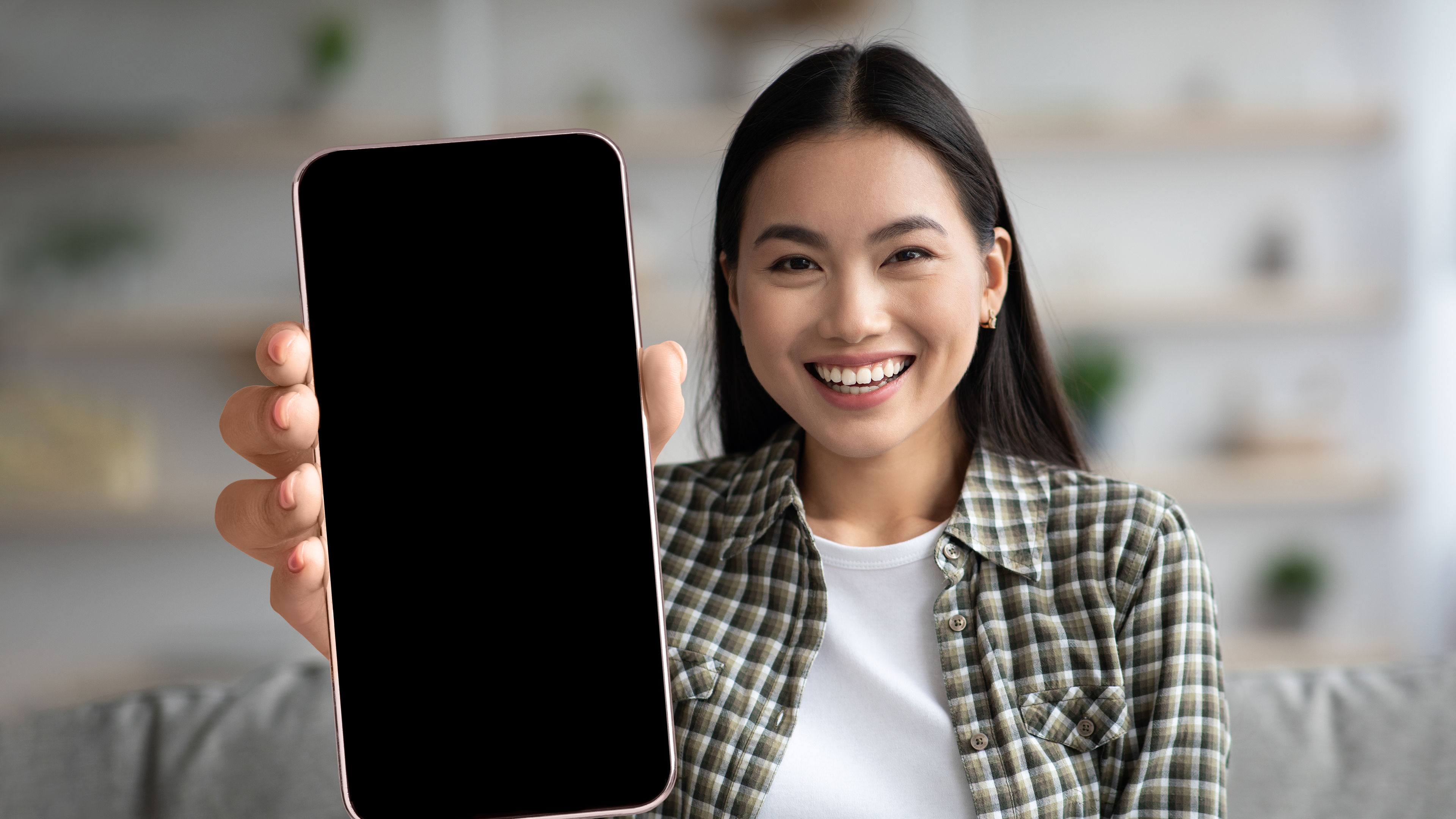 A woman with a smartphone in hand