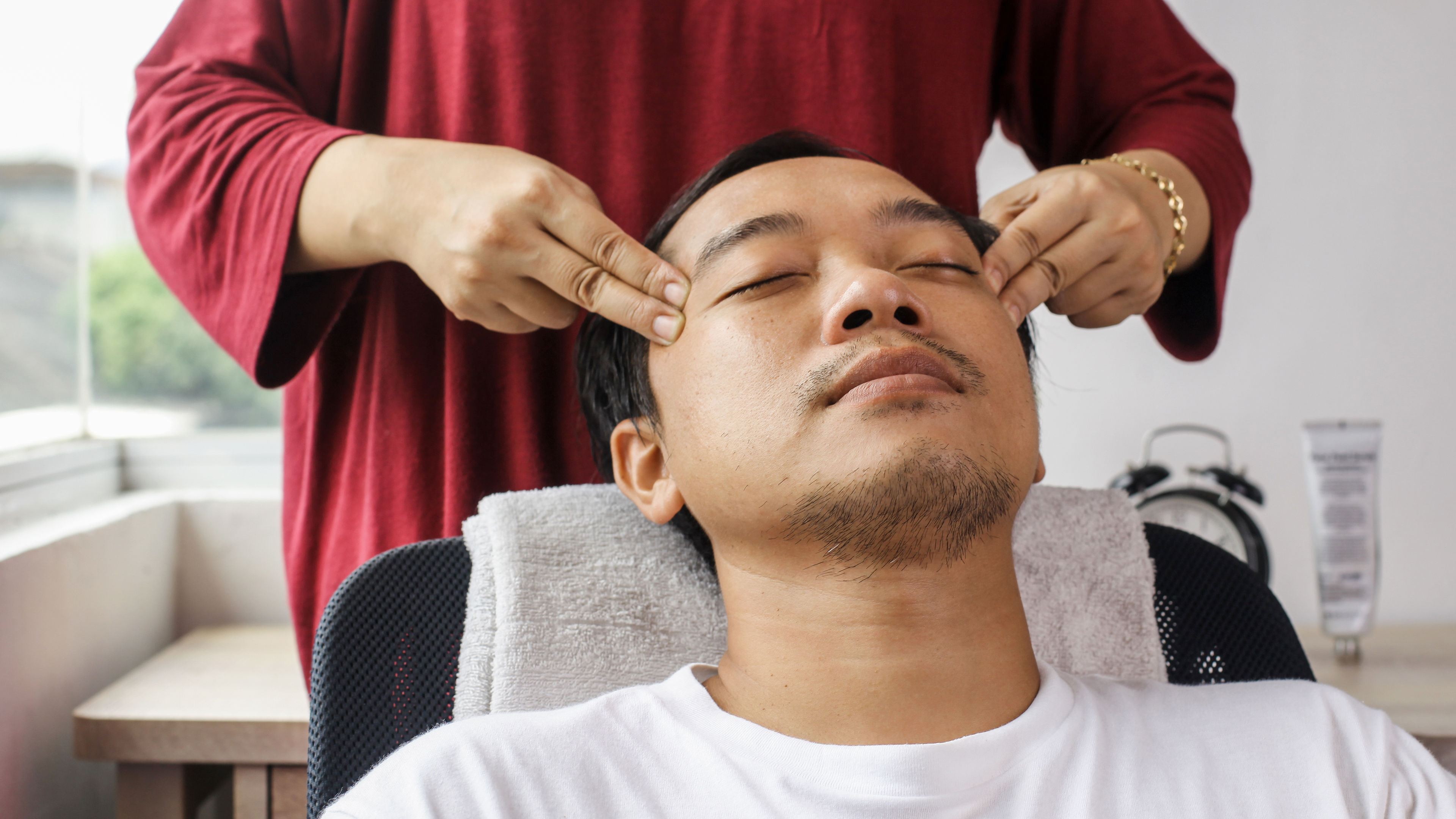 Man having face massage in spa salon