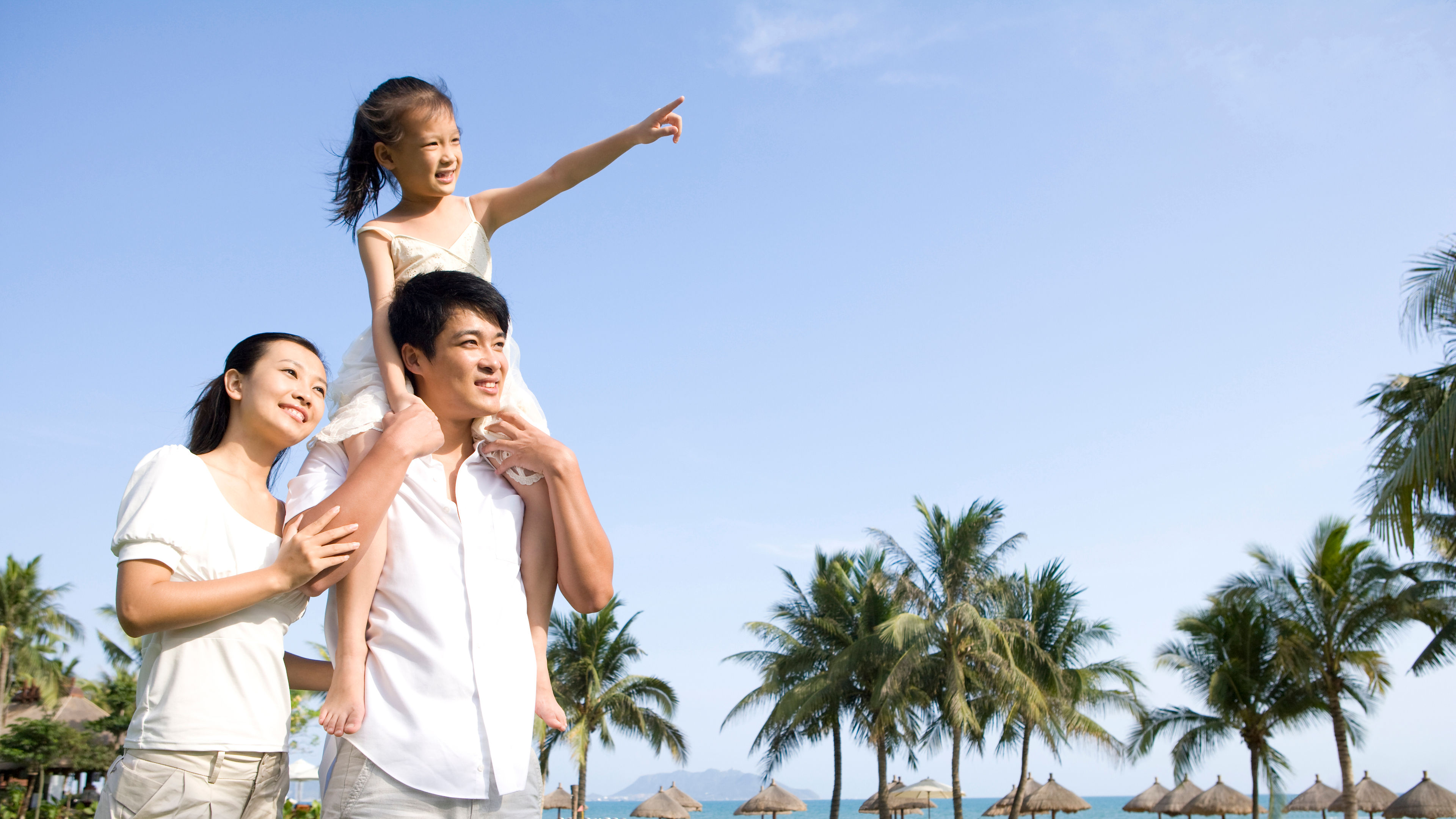 Portrait of a young Asian family in a tropical location