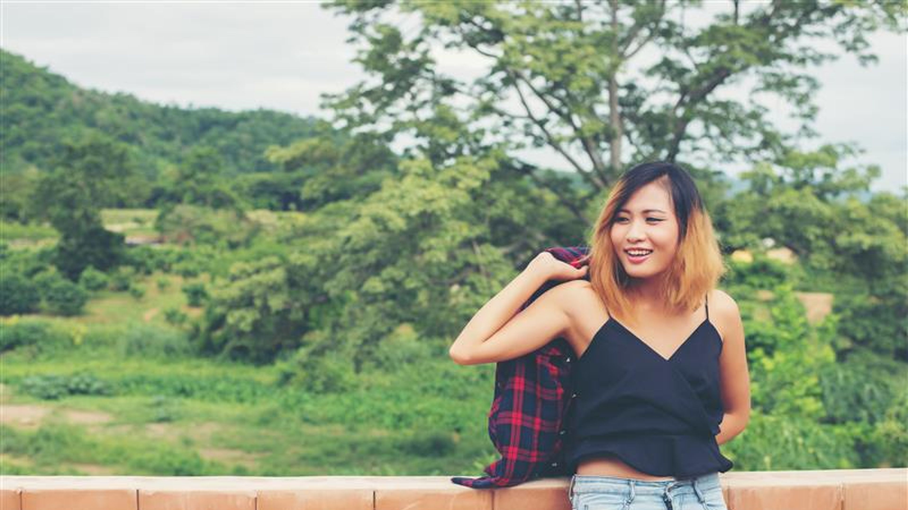 Portrait of young beautiful smiling woman outdoors