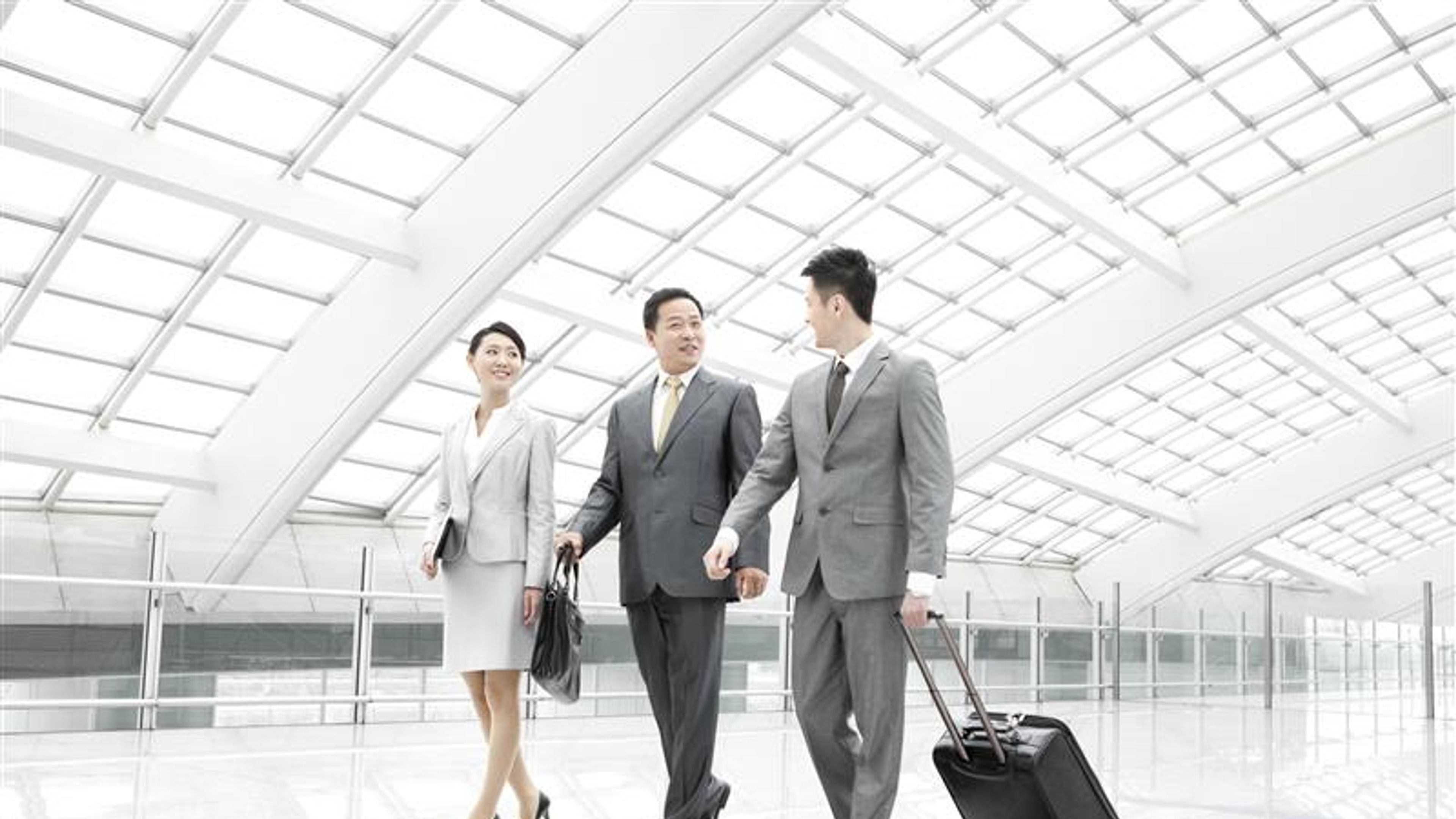 Some business people in an airport lobby.